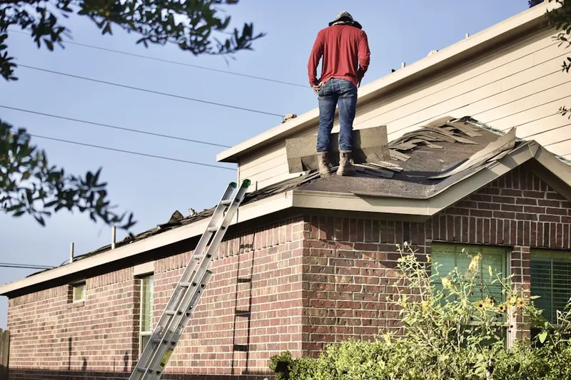 Professional roofer working on a residential roof in Montgomery